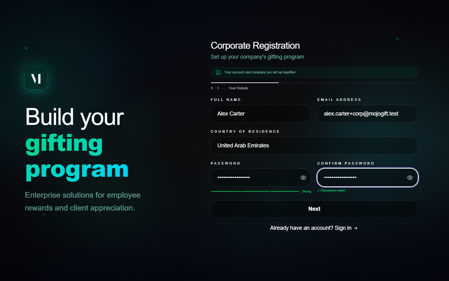 Step 1 of corporate registration filled in. Full Name Alex Carter, Email alex.carter+corp@mojogift.test, Country United Arab Emirates, password fields filled with a green strength bar labelled Strong and a green Passwords match indicator.