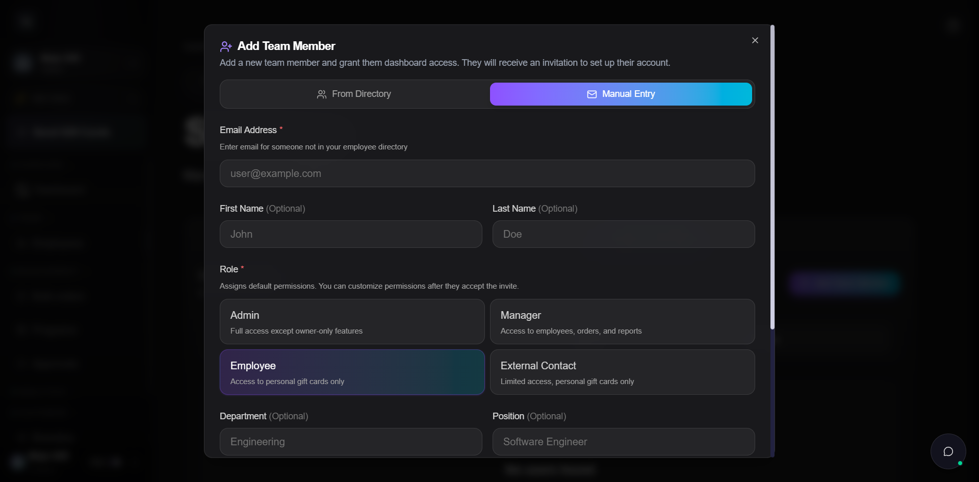 Add Team Member dialog open on the Manual Entry tab. Tab row shows From Directory and Manual Entry (active, gradient highlighted). Email Address (required) field with helper Enter email for someone not in your employee directory and placeholder user@example.com. First Name (Optional) and Last Name (Optional) fields side by side with placeholders John and Doe. Below, the same four role cards as the From Directory tab: Admin, Manager, Employee (currently selected), External Contact. Below the role grid, Department (Optional) and Position (Optional) fields are starting to appear at the bottom of the dialog.