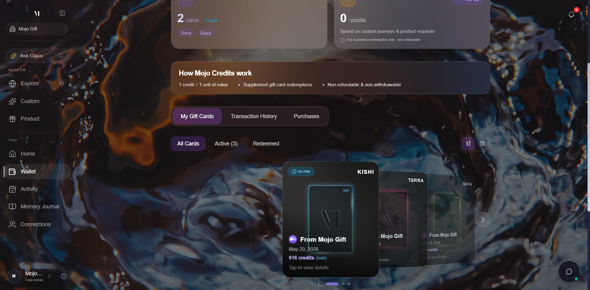 My Gift Cards tab active. Tab strip shows My Gift Cards selected, with Transaction History and Purchases beside it. Sub-tab strip below shows All Cards (active), Active (3), Redeemed. View toggle on the right with two icons (carousel and grid). Below, a horizontal carousel of three gift cards: an EXORA tier card centered with text From R Famorca, May 4, 2026, Tap to view details; a LUNARA card to the right; a TERRA card behind that. A 1/3 dot indicator below the carousel. Three quick links across the bottom: Curated Experiences, Request a Product, Custom Experience.